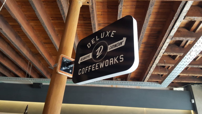 Coffee supplier sign with custom bracket detail